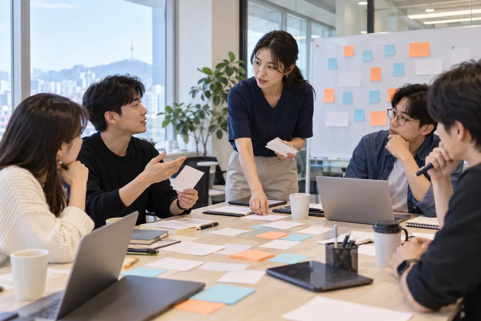 창업지원기관 담당자가 스타트업 창업자들과 질문 카드를 살펴보며 교육 의제를 정리하는 장면